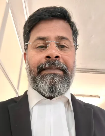 Advocate K. Neelamegam in High Court legal attire with advocate's bands